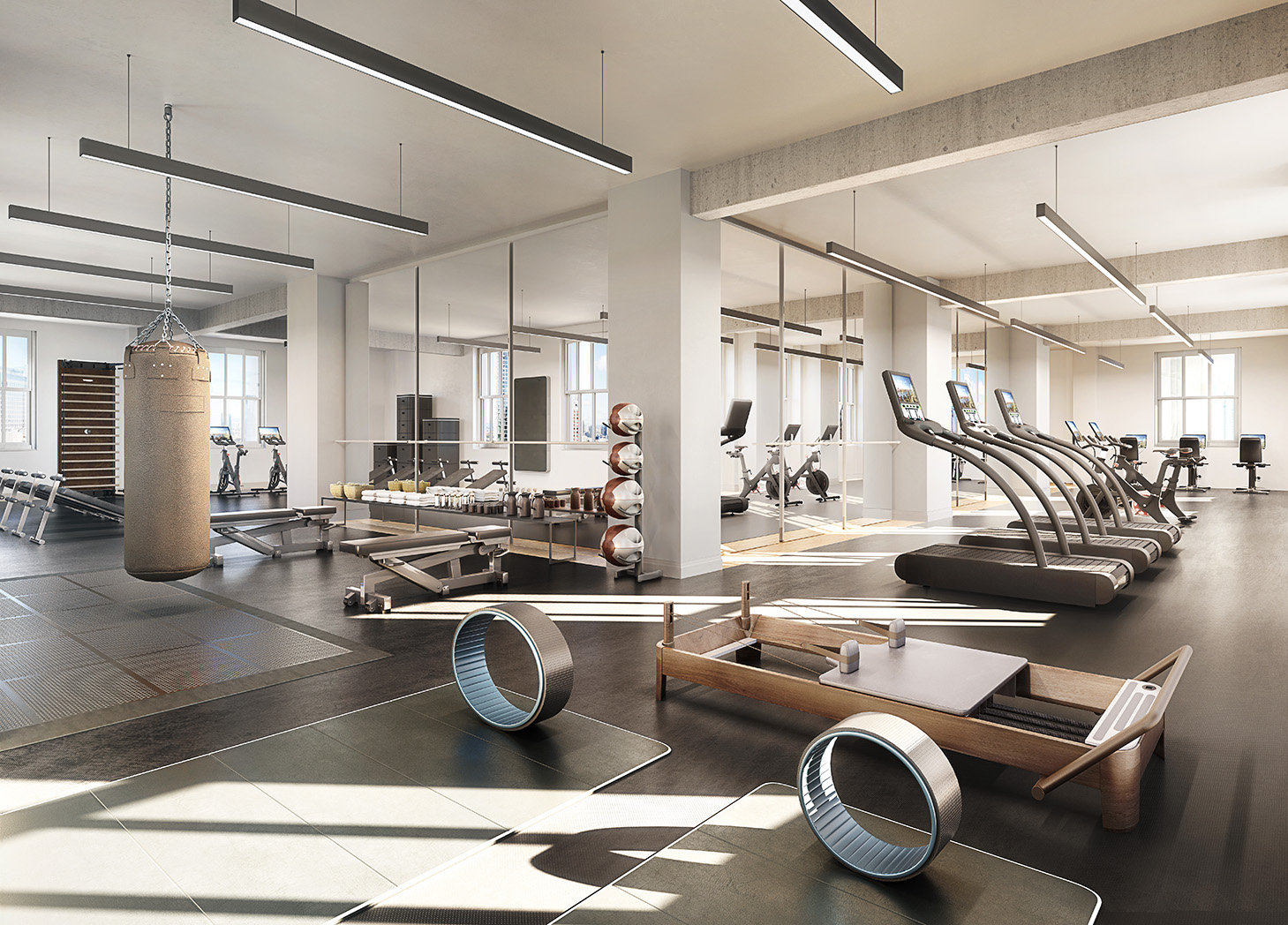 One Wall Street One Club gym filled with pilates, yoga, weightlifting, running, biking, and boxing equipment.